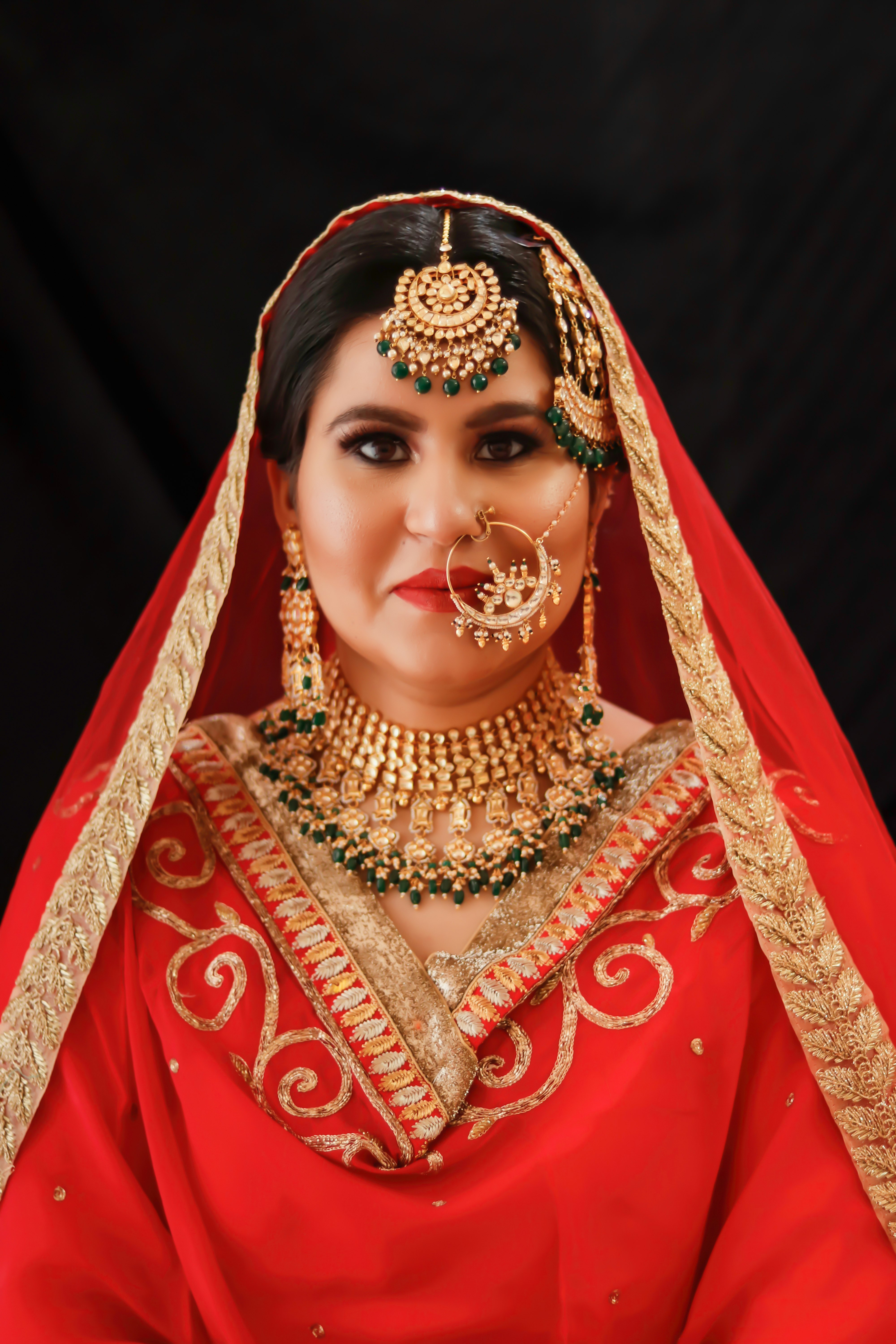 woman in red and gold sari